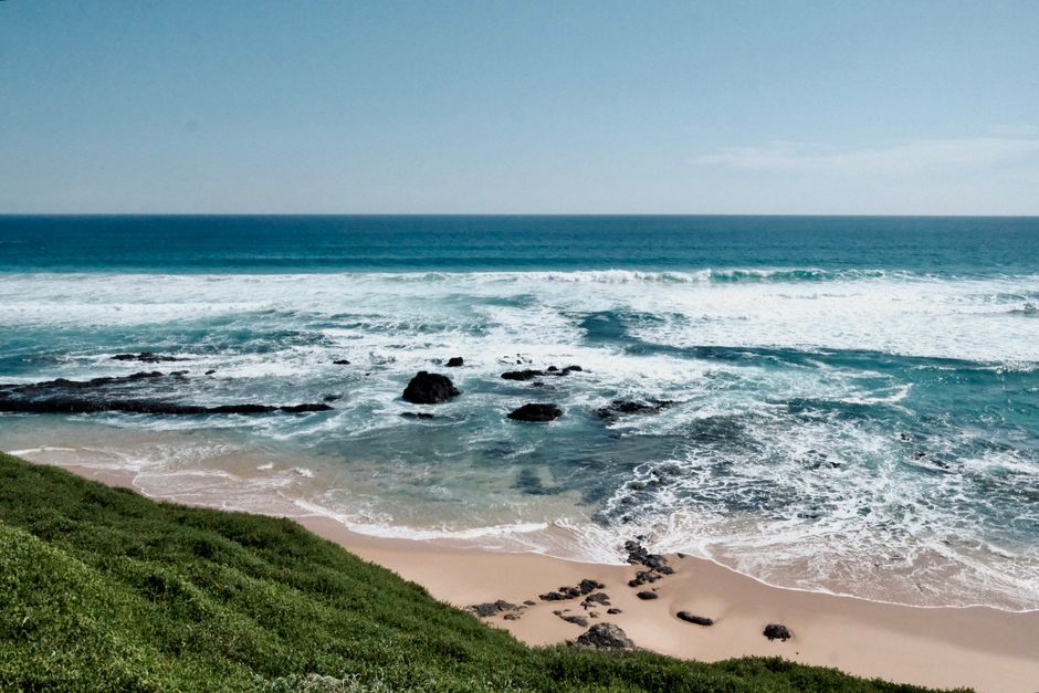 A tranquil beach scene with rolling waves and a sandy shore, perfect for nature lovers.