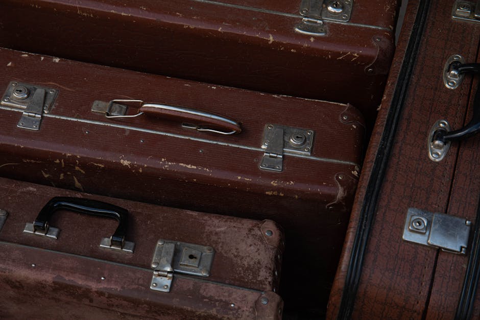 Close-up of vintage brown suitcases displaying classic design and texture.