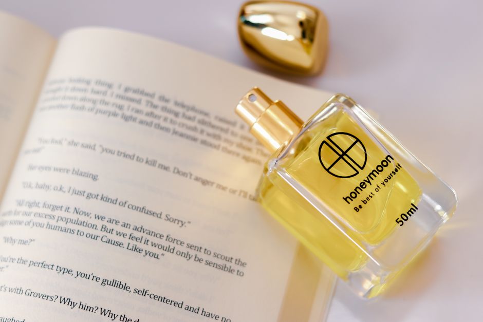 Elegant perfume bottle on an open book offers sophisticated and aromatic ambiance.