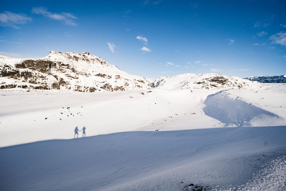 Experience the vast snowy expanse of Iceland's winter mountains with captivating shadows.