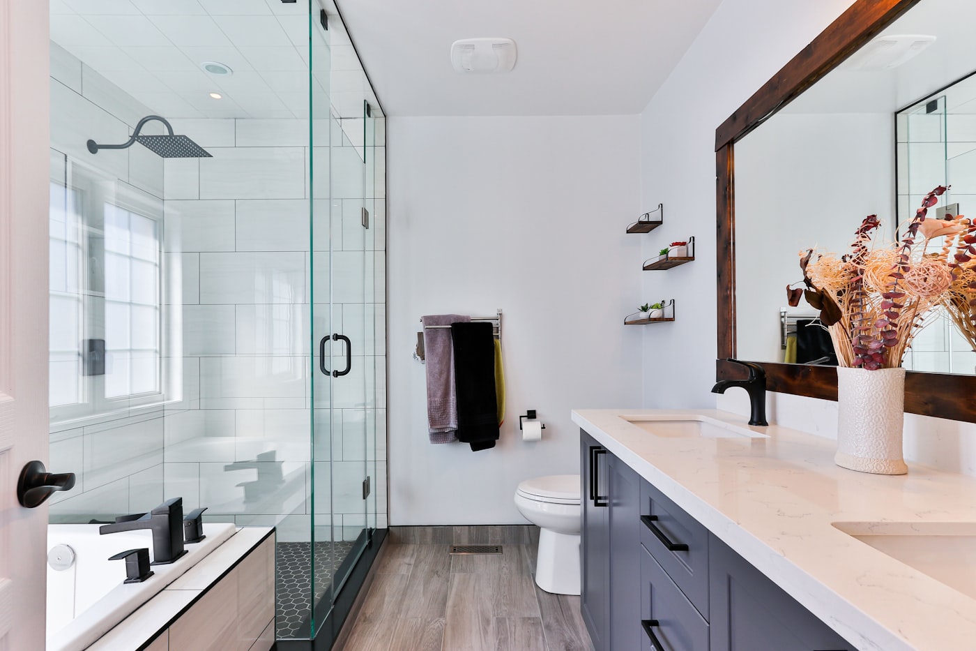 Clean hotel bathroom with walk in shower and mirror