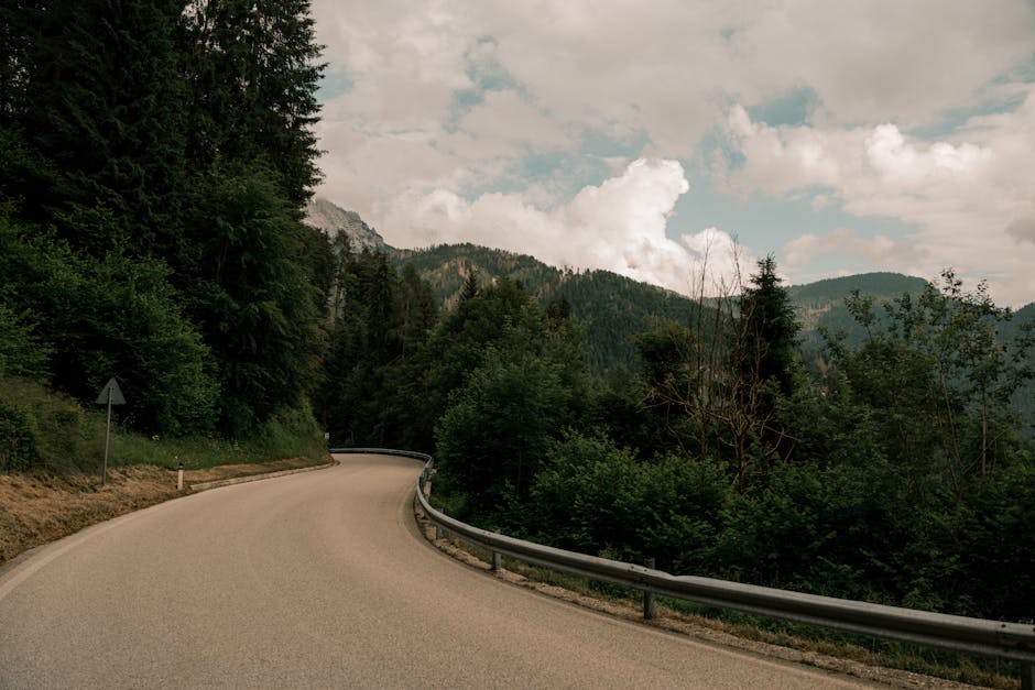 A winding road through lush mountains, creating a scenic and tranquil landscape.