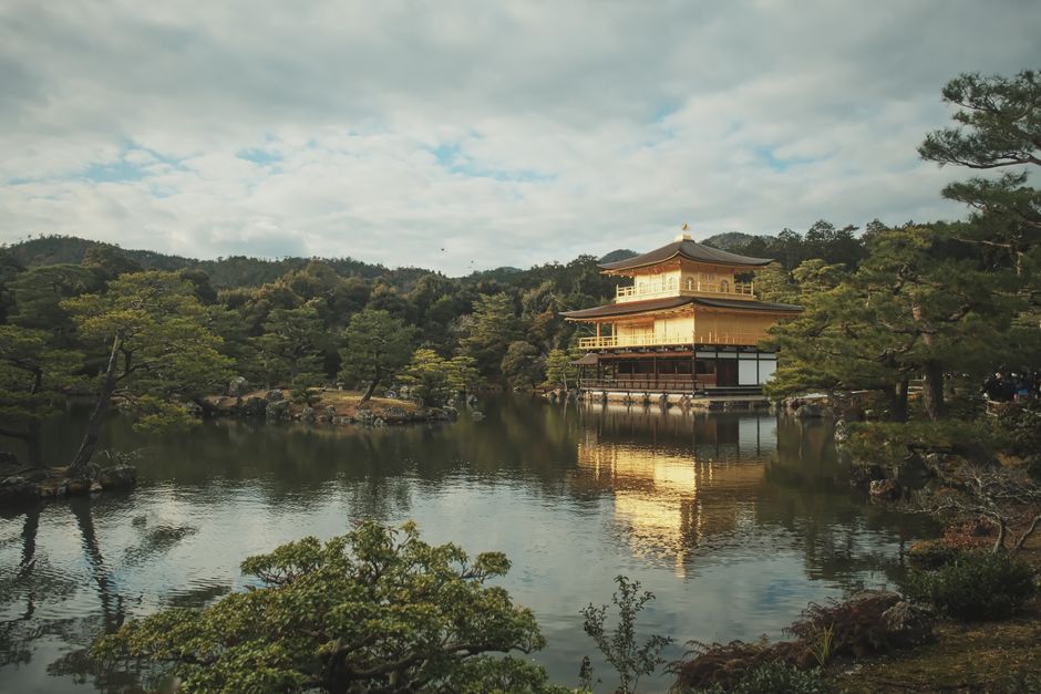 Scenic view of the Golden Pavilion reflecting on a serene lake at Kinkaku-ji Temple, Kyoto