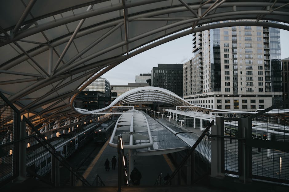 View of the sleek contemporary design at Denver Union Station with downtown buildings.