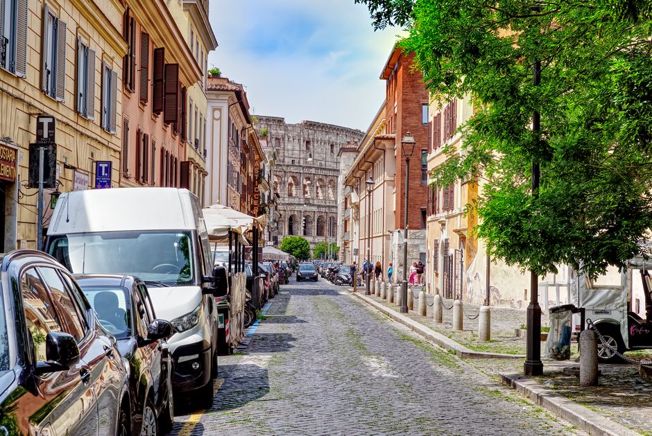 Charming street in Rome with Colosseum in view, vibrant and historic atmosphere.
